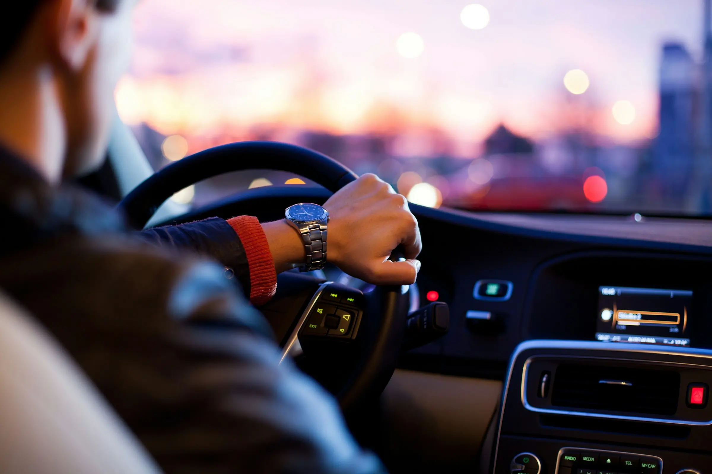 View across a car dashboard towards an open road; illustrative automotive photograph